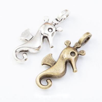 Group view of the seahorse charm showing the available finishes and front details