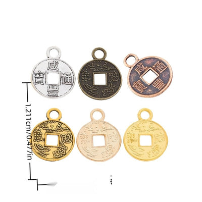 Assorted Chinese coin charms arranged together on a white background