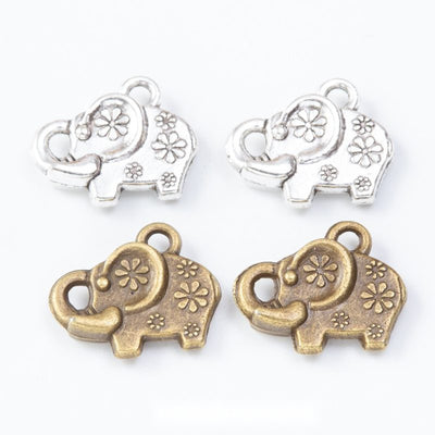 Group view of the small elephant charm showing the available finishes and front details