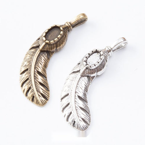 Group view of curved feather charm on a white background