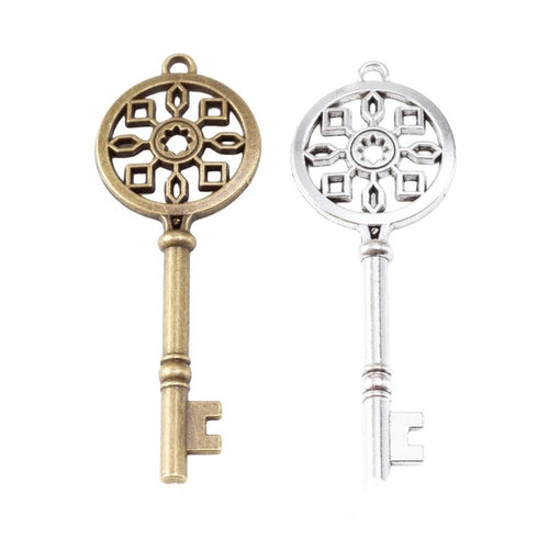 Group view of ornate round bow key charm on a white background
