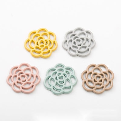 Group view of flat openwork rose bloom made from layered curved outlines
