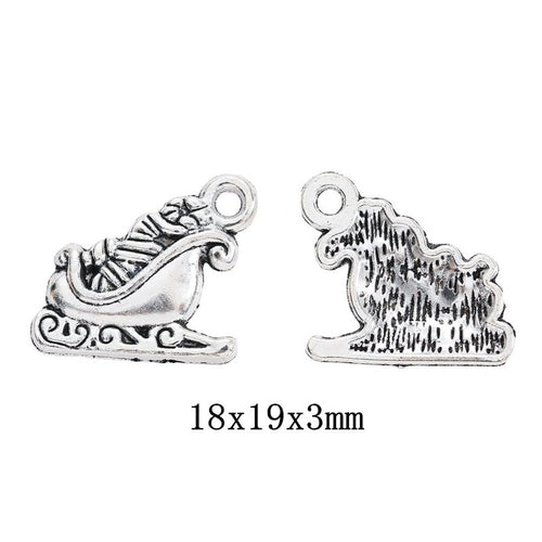 Front-facing arrangement of Christmas sleigh charms on a white background