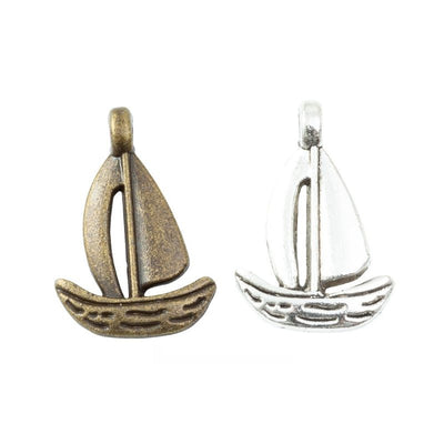 Sailboat Charm Pendant finish comparison showing a raised hull and two stylized sails