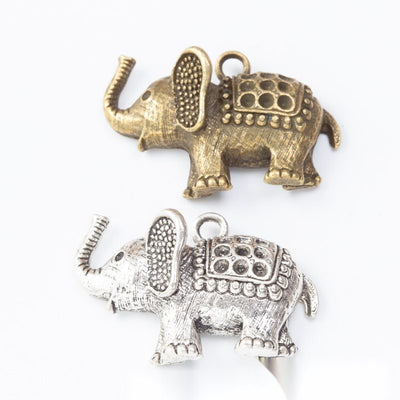 patterned elephant metal charms in two antique finishes shown together in the available finishes