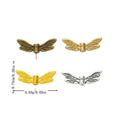 Assorted antique bronze, gold, light gold and antique silver feathered wing spacer bead pieces on white