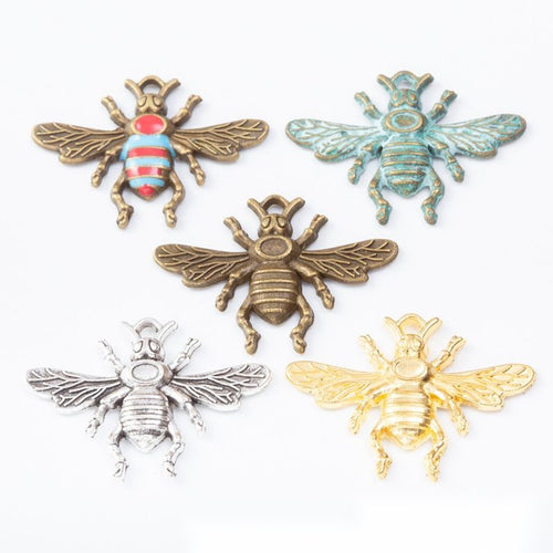 Group view of the bee charm showing the available finishes and front details