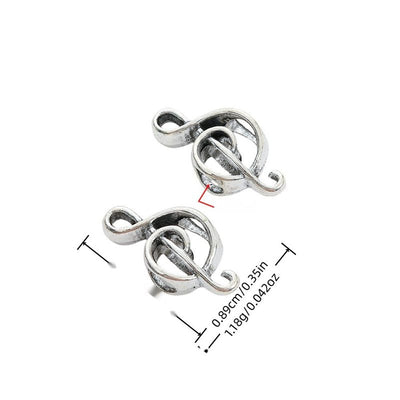 Front view of treble clef large-hole bead showing finish variation 1