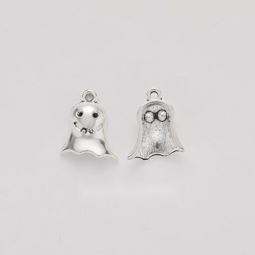 small smiling ghost metal charm shown from the front in the available metallic finishes