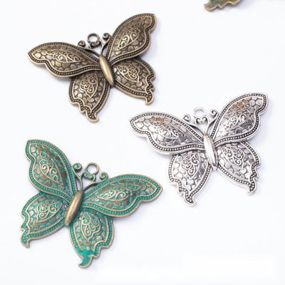 Overview of butterfly connector charm pieces on a white background
