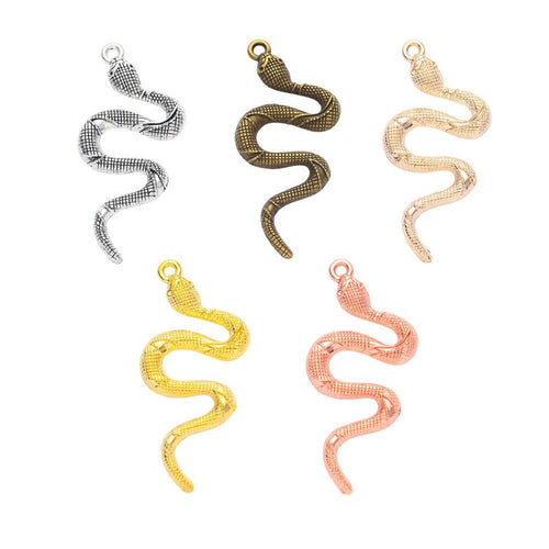 Overview of curved snake charm pieces on a white background