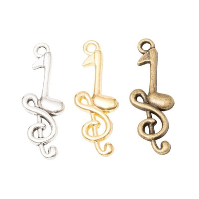 Front comparison of treble clef and note metal component in 3 finishes
