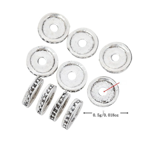 Flat round spacer bead with a raised rim and central hole shown in arranged finish comparison