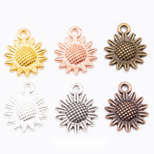 Overview of sunflower charm pieces on a white background