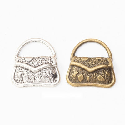 Patterned Handbag Charm Pendant finish comparison showing a curved handle and embossed front panels