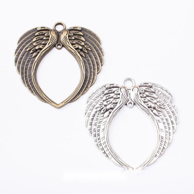 Group view of the winged heart charm showing the available finishes and front details