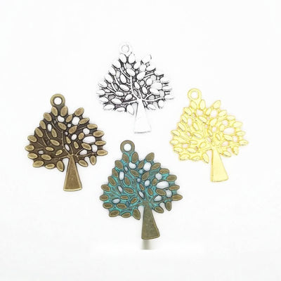 Openwork Tree Silhouette Metal Charms in Four Finishes in multiple metallic finishes displayed together on a white backg