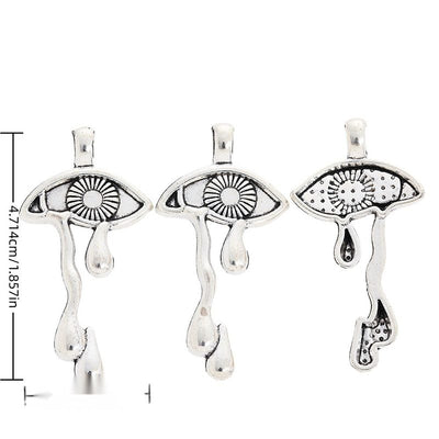 Crying Eye metal piece shown in Antique Silver beside printed specifications
