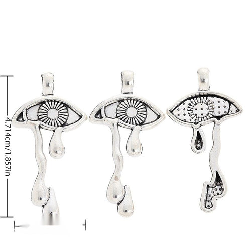 Crying Eye metal piece shown in Antique Silver beside printed specifications