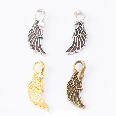 Lobster Clasp Wing Dangle Charms in Three Finishes in multiple metallic finishes displayed together on a white backgroun