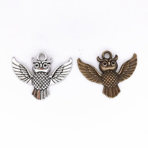 Group view of spread-wing owl charm showing all 2 pictured finish variants