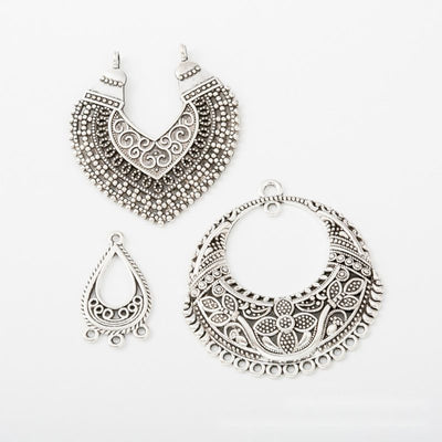 Product photo 1 of the ornate multi-loop connector highlighting its ornate openwork forms with multiple lower attachment