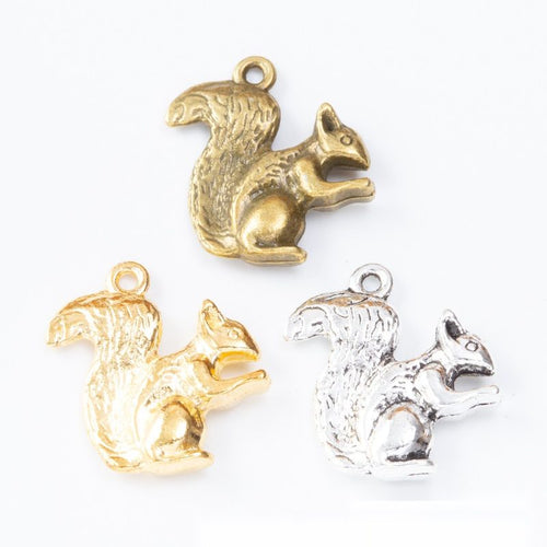 Assorted squirrel charm pendants displayed together on a white background