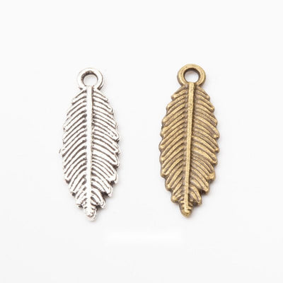 Product view of broad leaf charm showing a broad tapered leaf with deeply engraved veins and a round top loop