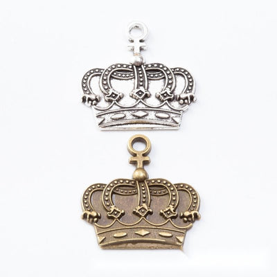 Openwork royal crown charms with rounded arches and a top loop arranged together on a white background.