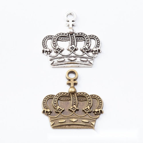 Openwork royal crown charms with rounded arches and a top loop arranged together on a white background.