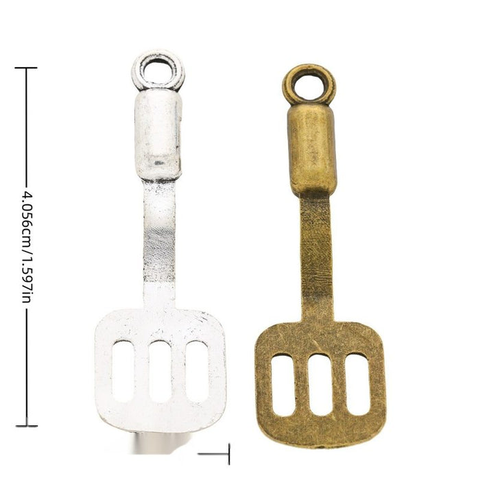Slotted Spatula Charm In Antique Bronze and Antique Silver Metal Finish