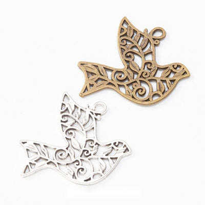 Filigree dove metal component, grouped front view on white