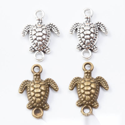Sea turtle connectors with patterned shells and loops at both ends arranged together on a white background.