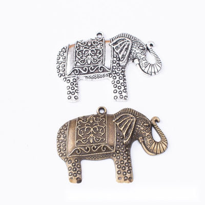 Group view of walking elephant silhouette with ornate blanket-like relief
