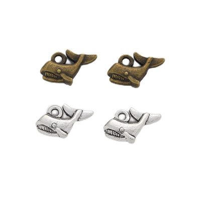 Tiny Whale Charm shown in all pictured finishes on a white background