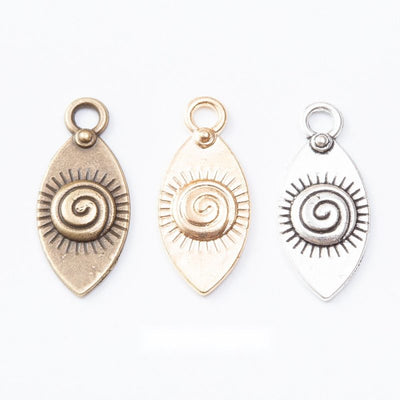 Group view of spiral eye teardrop charm on a white background
