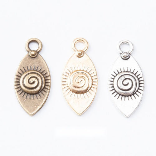 Group view of spiral eye teardrop charm on a white background