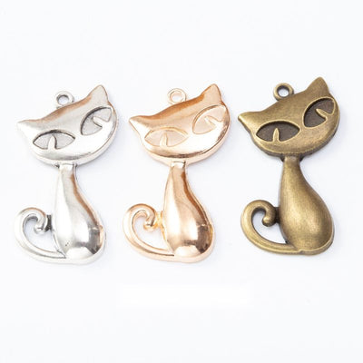 Sitting Cat metal pieces shown in the available finishes.