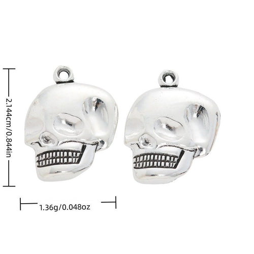 Product image showing the grinning skull head metal charm and its visible metal details