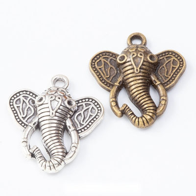 ornate elephant head pendant charms in two finishes shown together in the available finishes