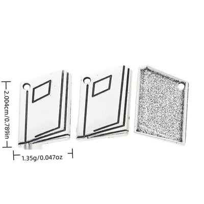 Open Book metal piece shown in Antique Silver beside printed specifications