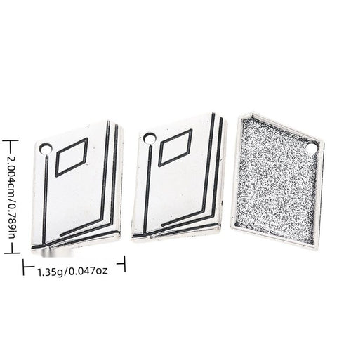 Open Book metal piece shown in Antique Silver beside printed specifications
