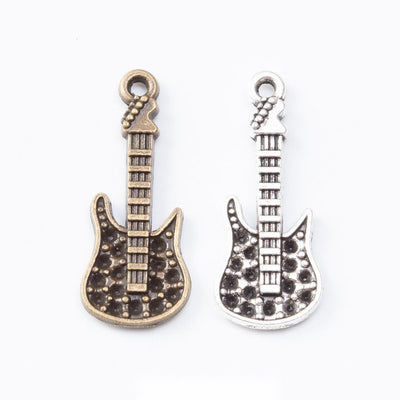 Electric guitar charms with raised strings, frets, and body details arranged together on a white background.