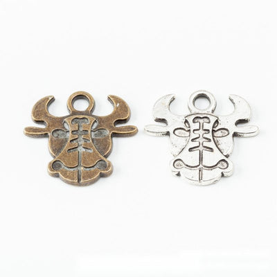 Product view of ox head charm showing a stylized ox head with broad horns, engraved facial lines, and a top loop