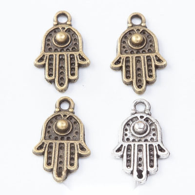 Assorted Hamsa hand charms arranged together on a white background