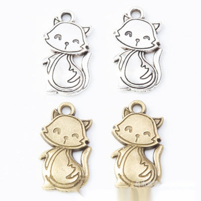Scarf-wearing cat metal component, grouped front view on white
