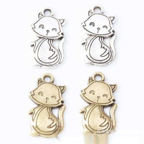 Scarf-wearing cat metal component, grouped front view on white