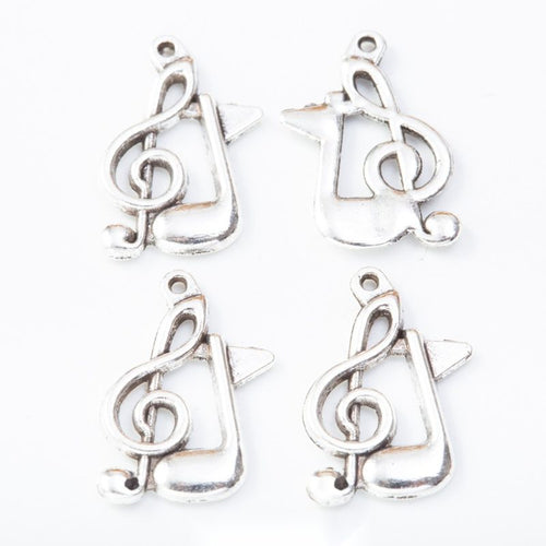 Group view of treble clef music note charm on a white background
