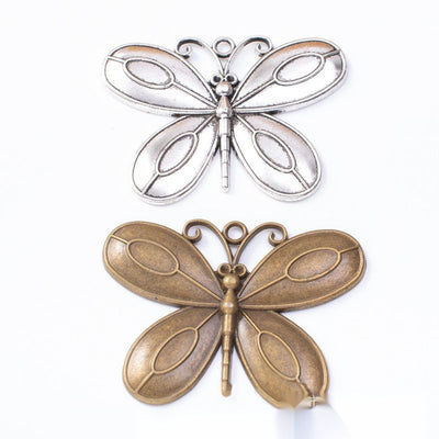 Overview of layered butterfly charms in the available designs and finishes
