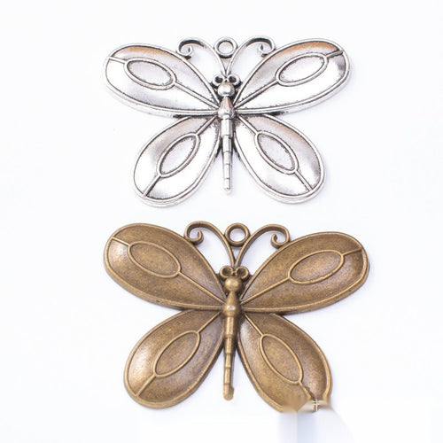 Overview of layered butterfly charms in the available designs and finishes